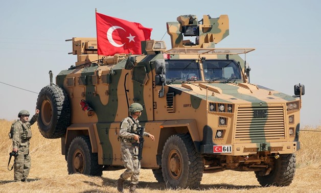 FILE PHOTO: A Turkish soldier walks next to a Turkish military vehicle during a joint U.S.-Turkey patrol, near Tel Abyad, Syria September 8, 2019. REUTERS/Rodi Said/File Photo
