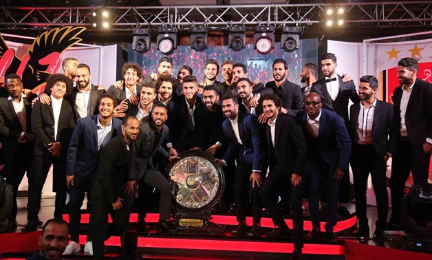 File- Al_Ahly players pose with the league trophy