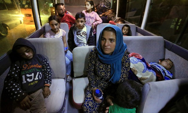 Syrian displaced families, who fled violence after the Turkish offensive against Syria, sit in a bus after arrival at a refugee camp in Bardarash on the outskirts of Dohuk, Iraq October 17, 2019. REUTERS/Ari Jalal