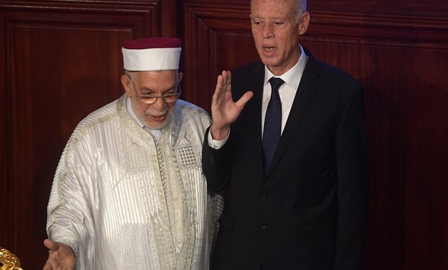 Kais Saied (R) takes the oath of office near acting Tunisian parliament speaker Abdelfattah Mourou on October 23, 2019, in Tunis. Fethi Belaid/AFP