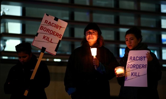 Anti-racism campaigners take part in a vigil, following the discovery of 39 bodies in a truck container on Wednesday, outside the Home Office in London, Britain October 24, 2019. REUTERS/Hannah McKay
