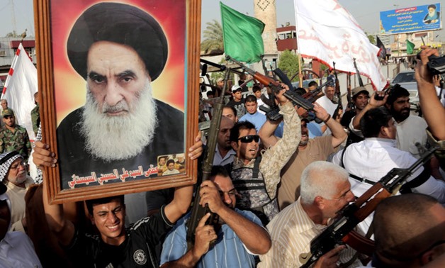 FILE: Protesters holding a picture of Sh'ite Cleric Grand Ayatollah Ali al-Sistani 
