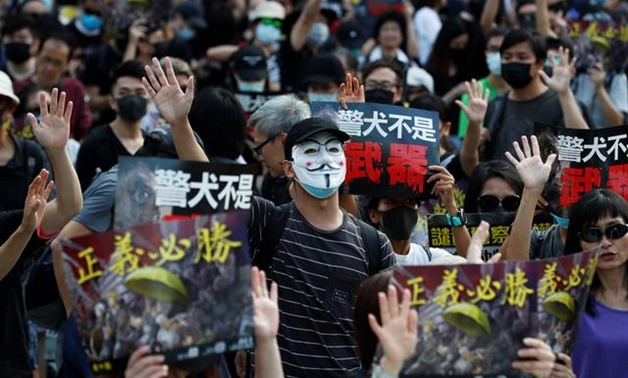 An anti-government demonstrator wearing a Anonymous mask attends a protest in Hong Kong's tourism district of Tsim Sha Tsui, China October 27, 2019. REUTERS/Kim Kyung-Hoon
