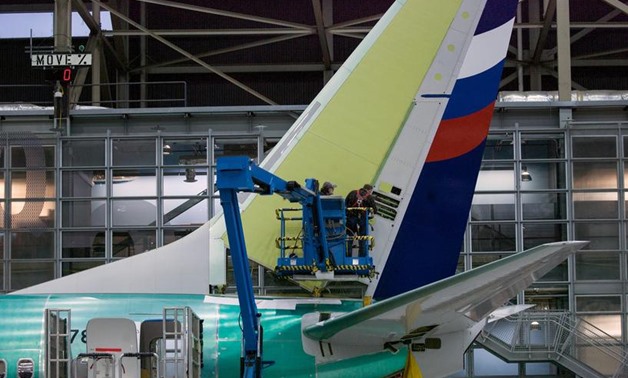 FILE PHOTO: Boeing employees work on the tail of a Boeing 737 NG at the Boeing plant in Renton, Washington December 7, 2015. REUTERS/Matt Mills McKnight
