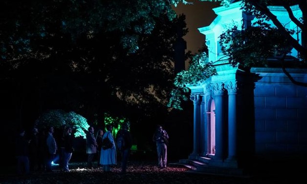 Tourists look at the Webb family mausoleum during the Moonlight Mausoleum tour at Woodlawn Cemetery in Bronx in New York City, New York, U.S., October 25, 2019. REUTERS/Jeenah Moon