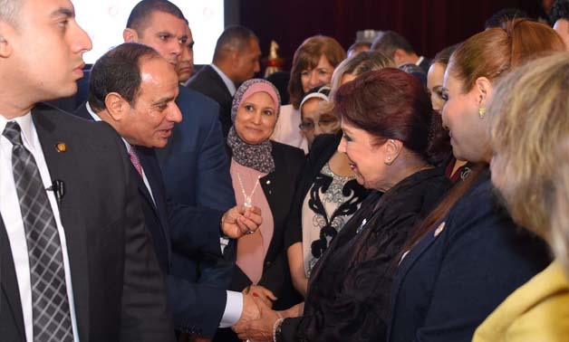 President Abdel Fatah al-Sisi standing with public figures, including actress Ragaa el-Gedawy during a June 3 Iftar - Press photo