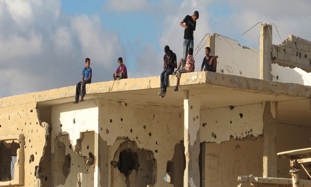 Children play on  top of a bullet-riddled building in Gaza –
 Photo credit UN – Shareef Sarhan