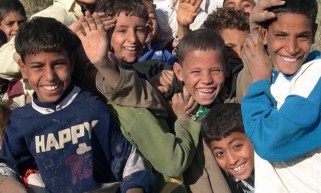 Children jostle playfully for the best spot in front of the camera- CC via Flickr/ Mohammed Shamma