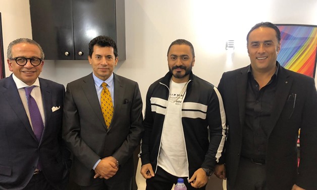 (From right to left) Presentation Company head Montasser el Nabarawy, singer Tamer Hosny, and other representatives pose for a picture- press photo