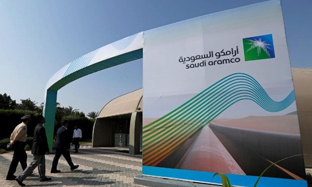 FILE PHOTO: The logo of Aramco is seen as security personnel walk before the start of a press conference by Aramco at the Plaza Conference Center in Dhahran, Saudi Arabia November 3, 2019. REUTERS/Hamad I Mohammed/File Photo

