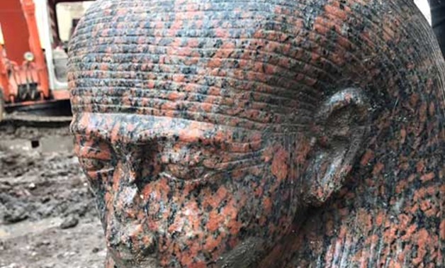 File-A unique royal bust of King Ramses II made of red granite.