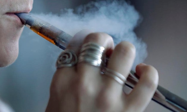 A woman using a vaping device exhales a puff of smoke in Mayfield Heights, Ohio. (File photo: AP)