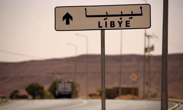 A road sign shows the direction of Libya near the border crossing at Dhiba, Tunisia April 11, 2016. REUTERS/Zohra Bensemra
