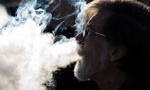 A demonstrator vapes during a consumer advocate groups and vape storeowners rally outside of the White House to protest a proposed vaping flavor ban on November 9, 2019. (Jose Luis Magana / AFP)
