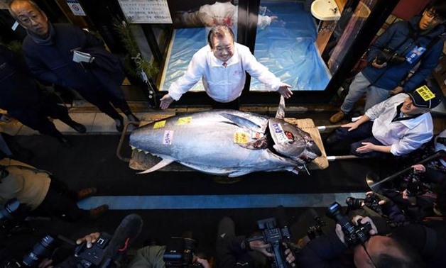 Kiyoshi Kimura, president of Kiyomura Corp., operator of Japanese sushi chain Sushizanmai, poses with a bluefin tuna that was auctioned for 193 million Japanese yen (about $1.8 million) in Tokyo, Japan January 5, 2020. Mandatory credit Kyodo/via REUTERS
