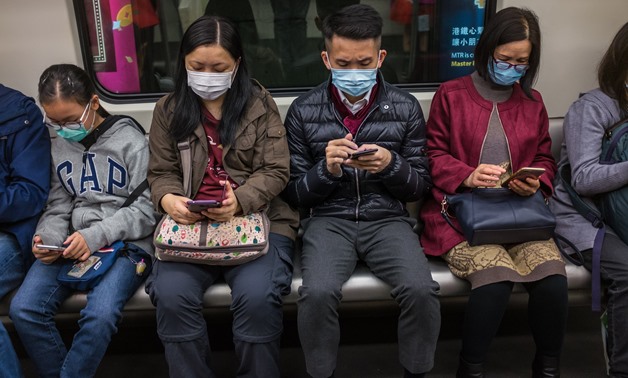 People wear masks on a train on the first day of the Lunar New Year of the Rat in Hong Kong on January 25, 2020, as a preventative measure following a coronavirus outbreak which began in the Chinese city of Wuhan. Hong Kong on January 25 declared a myster