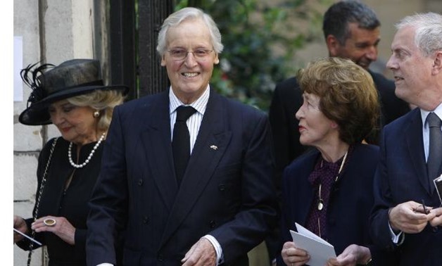FILE PHOTO: British entertainers Nicholas Parsons (2nd L) and Gyles Brandreth (R) leave the funeral of Clement Freud at St Bride's church in London April 24, 2009. Freud was the grandson of Sigmund Freud, and his funeral took place on Friday, which would 