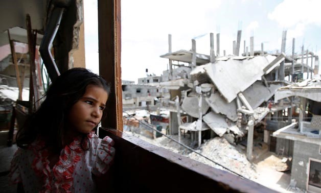 A Palestinian girl stands in a damaged building - photo courtesy of UN official website