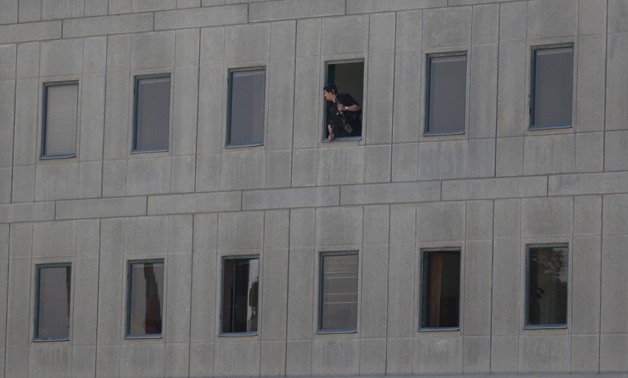 An Iranian policeman looks out of the parliament's building in central Tehran, Iran, June 7, 2017.