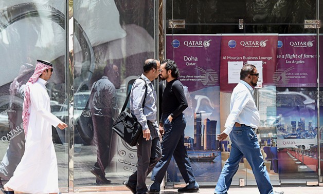 Diplomatic crisis: A picture taken on June 5 shows people walking past the Qatar Airways branch in the Saudi capital Riyadh, after it suspended all flights to Saudi Arabia following a severing of relations between major gulf states and gas-rich Qatar. Ara