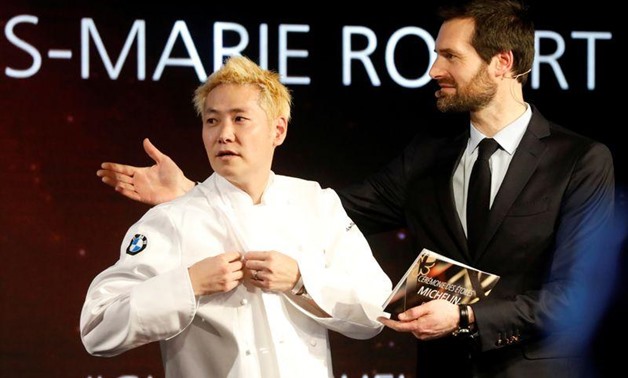 Newly awarded three-star Michelin chef Kei Kobayashi of Kei restaurant reacts on stage next to Gwendal Poullennec, International Director of Michelin Guides, during the Michelin Guide 2020 award ceremony in Paris, France, January 27, 2020. REUTERS/Charles