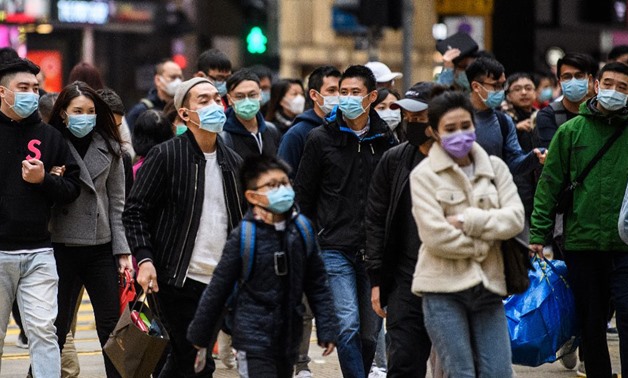 Pedestrians wearing face masks cross a road during a Lunar New Year of the Rat public holiday in Hong Kong on January 27, 2020, as a preventative measure following a coronavirus outbreak which began in the Chinese city of Wuhan - AFP
