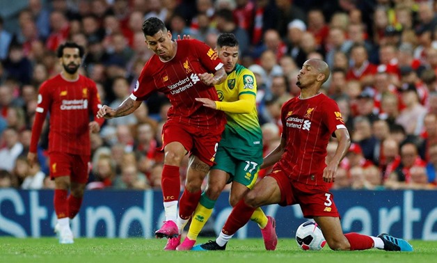 Soccer Football - Premier League - Liverpool v Norwich City - Anfield, Liverpool, Britain - August 9, 2019 Norwich City's Emiliano Buendia in action with Liverpool's Fabinho and Roberto Firmino REUTERS/Phil Noble