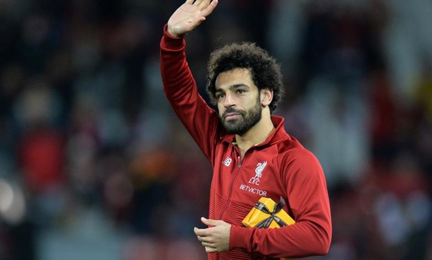 FILE PHOTO: Soccer Football - Champions League - Group Stage - Group C - Liverpool v Crvena Zvezda - Anfield, Liverpool, Britain - October 24, 2018 Liverpool's Mohamed Salah with a gift from a fan after the match REUTERS/