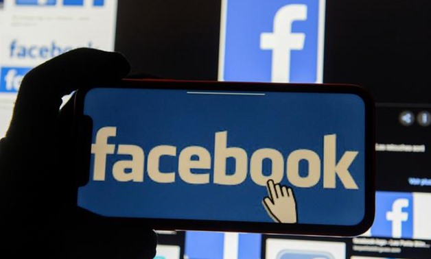 FILE PHOTO: The Facebook logo is displayed on a mobile phone in this picture illustration taken December 2, 2019. REUTERS/Johanna Geron/Illustration - RC2OND9JJLZ0/File Photo
