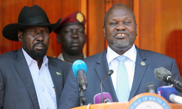 FILE PHOTO: South Sudan's ex-vice President and former rebel leader Riek Machar flanked by President Salva Kiir Mayardit address a news conference at the State House in Juba, South Sudan February 20, 2020. REUTERS/Jok Solomun
