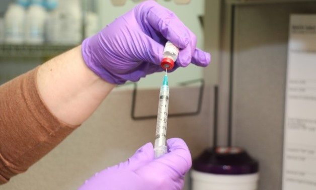 FILE – A syringe filled with vaccination – Courtesy of the US Army