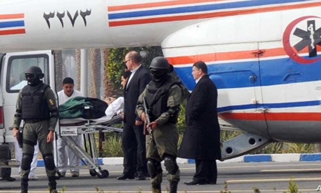 Former Egyptian president Hosni Mubarak is carried from an ambulance to a helicopter for his trial in Cairo, Egypt, Thursday, Jan. 5, 2012. AP Photo