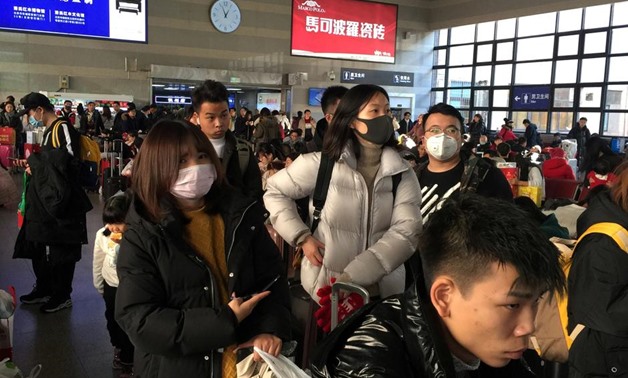 Passengers wearing masks wait to board trains at the Beijing West Railway Station, in Beijing, China January 20, 2020. REUTERS/Stringer