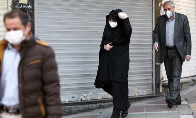 Iranian people wear protective masks to prevent contracting a coronavirus, in Tehran, Iran February 29, 2020.WANA (West Asia News Agency)/Nazanin Tabatabaee via REUTERS
