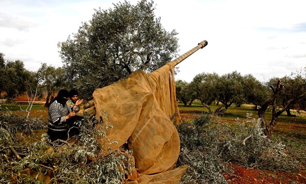 Syrian fighters set a target to an artillery near Idlib, Syria February 27, 2020. REUTERS/Umit Bektas