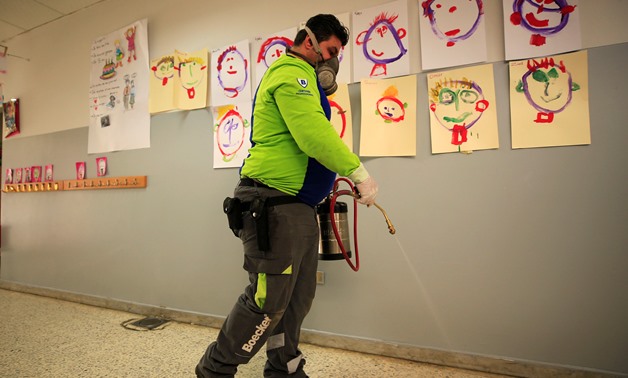 An employee from a disinfection company sanitizes a closed school, as a precaution against the spread of the coronavirus, in Sidon, Lebanon February 29, 2020. REUTERS/Ali Hashisho
