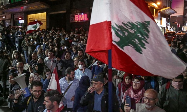 Lebanese anti-government protesters marching towards downtown Beirut on Thursday. Financial Prosecutor Ali Ibrahim had issued an order freezing the assets of 20 banks, which caused the banks to threaten to close.  EPA

