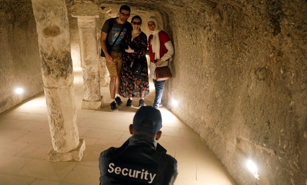 A security guard takes a photograph of tourists inside the standing step pyramid of Saqqara after its renovation, south of Cairo, Egypt March 5, 2020. REUTERS/Mohamed Abd El Ghany