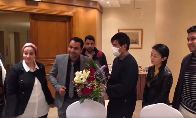 Egyptians offering the Chinese man flowers - still image from Facebook video by Fayhaa Wang