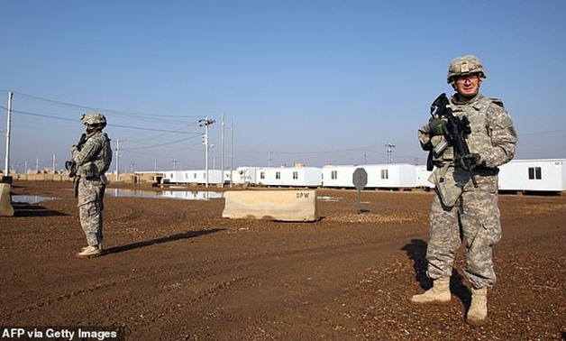 US soldiers walk around at the Taji base complex in Iraq which hosts Iraqi and US troops (pictured in 2014).