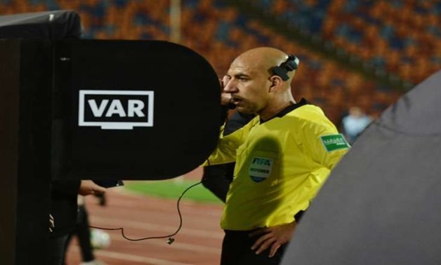 Egyptian referee, Mohamed Adel, reviews a penalty case decision during Al Ahly clash against Smouha 