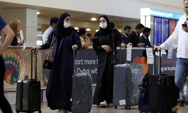 FILE PHOTO: Travellers wear masks as they arrive at the Dubai International Airport, after the UAE's Ministry of Health and Community Prevention confirmed the country's first case of coronavirus, in Dubai, United Arab Emirates January 29, 2020. REUTERS/Ch