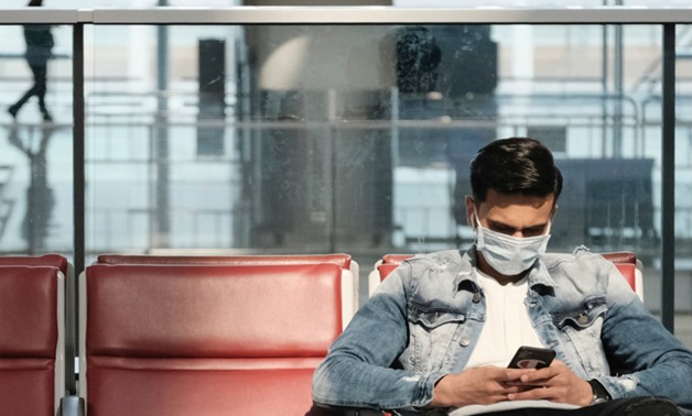 A passenger wears a protective face mask at Hong Kong's airport following the coronavirus outbreak. REUTERS. A passenger wears a protective face mask at Hong Kong's airport following the coronavirus outbreak. REUTERS