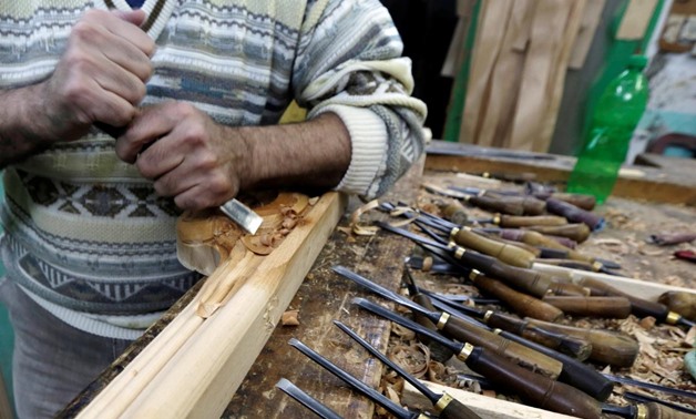 An Egyptian craftsman handles wood parts for furniture at his workshop in the city of Damietta, Egypt January 14, 2020. Picture taken January 14, 2020. REUTERS/Hayam Adel