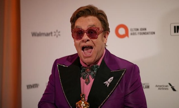 FILE PHOTO: Elton John attends the 28th Annual Elton John AIDS Foundation Academy Awards Viewing Party, holding the Oscar for Best Original Song for "(I'm Gonna) Love Me Again" from "Rocketman", which he won with Bernie Taupin at the 92nd Academy Awards, 