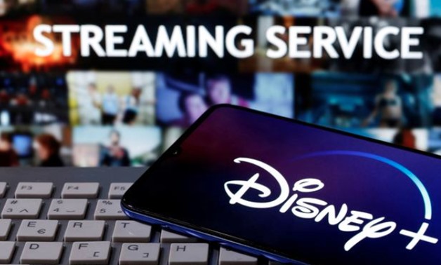 FILE PHOTO: A smartphone with displayed "Disney" logo is seen on the keyboard in front of displayed "Streaming service" words in this illustration taken March 24, 2020. REUTERS/Dado Ruvic
