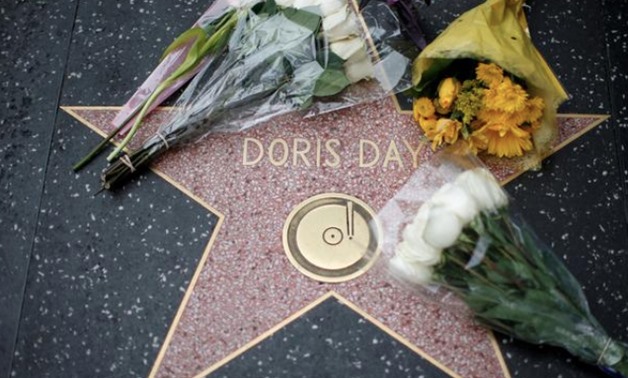 FILE PHOTO: Flowers are pictured by the star of late actor Doris Day on the Hollywood Walk of Fame in Los Angeles, California, U.S., May 13, 2019. REUTERS/Mario Anzuoni/File Photo