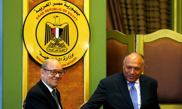 French Foreign Minister Jean-Yves Le Drian shakes hand with Egyptian Foreign Minister Sameh Shoukry (R) after their joint news conference - REUTERS/Amr Abdallah Dalsh
