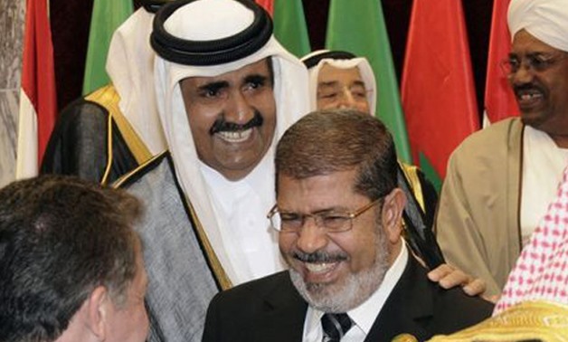 Egypt's President Mohammed Morsi and Qatari Emir Hamad bin Khalifa Al Thani at the opening ceremony of the Organization of Islamic Conference summit - REUTERS/Hassan Ali