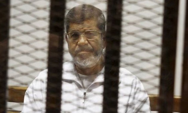 Former president Mohamed Morsi behind bars - File photo